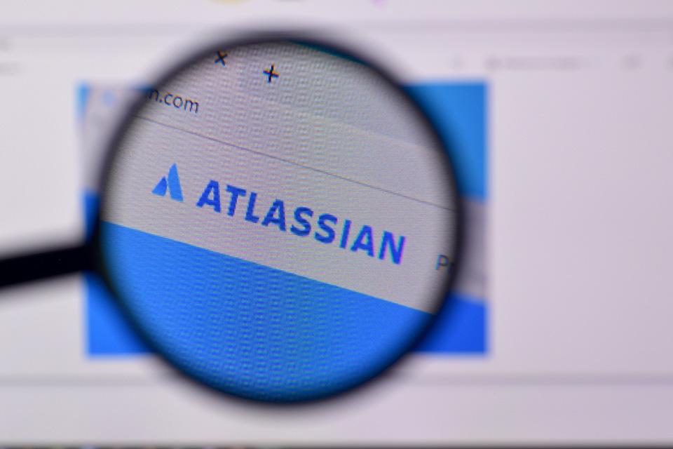 The homepage of Atlassian website is displayed on a PC.