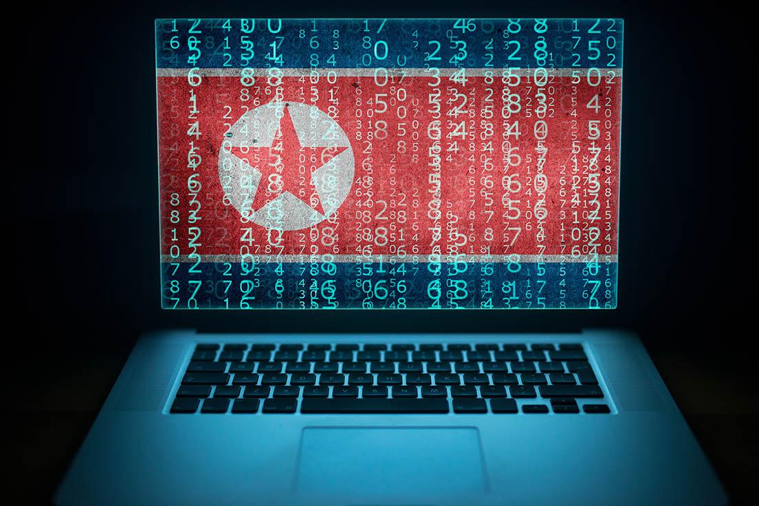 Laptop with binary computer code and Korean flag on the screen.